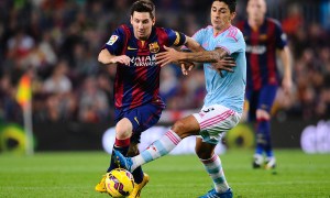 FC Barcelona's Lionel Messi, left, duels for the ball against Celta de Vigo's Pablo Hernandez during a Spanish La Liga soccer match at the Camp Nou stadium in Barcelona, Spain, Saturday, Nov. 1, 2014. (AP Photo/Manu Fernandez)
